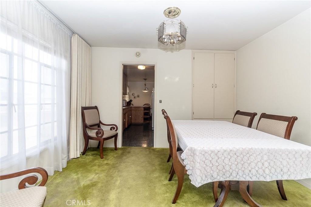630 Acoma Street Needles, CA 92363 - Photo 11 of 60 a bedroom with a bed and chandelier