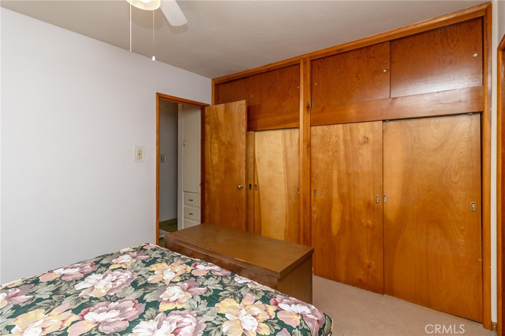 630 Acoma Street Needles, CA 92363 - Photo 23 of 60 a bedroom with a bed and a table in it