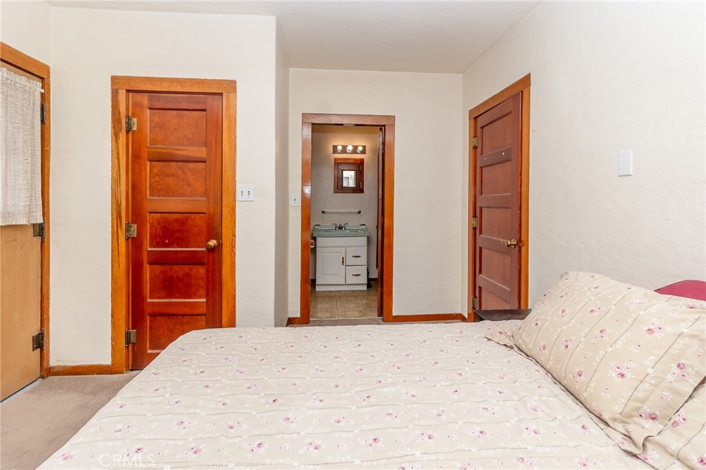 630 Acoma Street Needles, CA 92363 - Photo 42 of 60 a bedroom with a bed and wooden floor