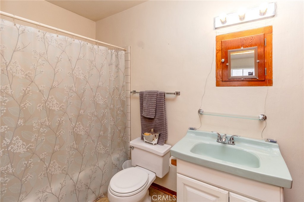 630 Acoma Street Needles, CA 92363 - Photo 43 of 60 a bathroom with a sink toilet and mirror