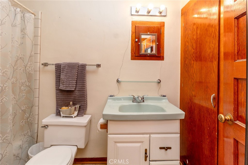 630 Acoma Street Needles, CA 92363 - Photo 44 of 60 a bathroom with a toilet a sink and mirror