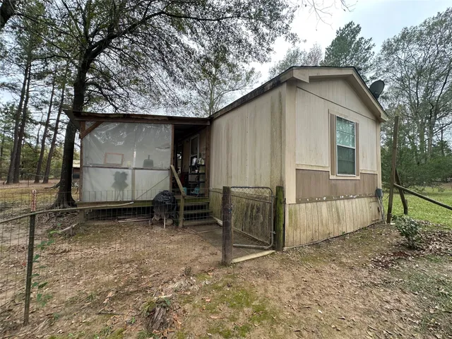 a backyard of a house with barbeque oven