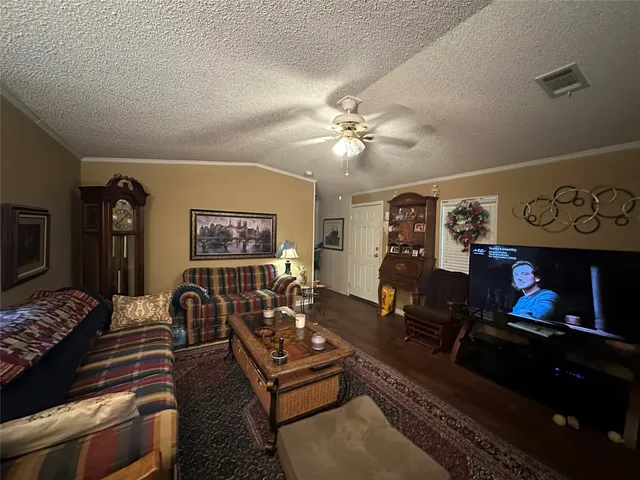 a living room with furniture a fireplace and flat screen tv