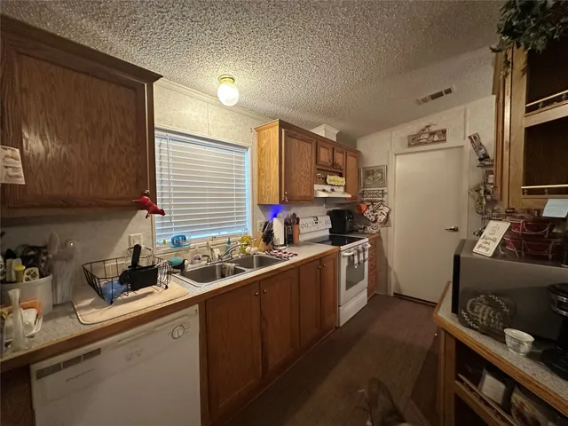 a kitchen with a sink stove and refrigerator