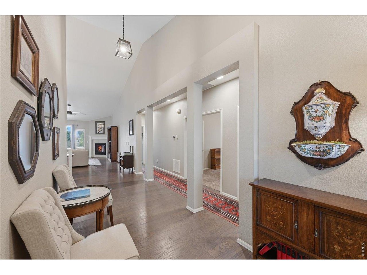 6096 Story Road Timnath, CO 80547 - Photo 2 of 50 a living room with furniture a rug and a wall painting