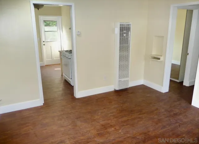 an empty room with a bathroom and a sink
