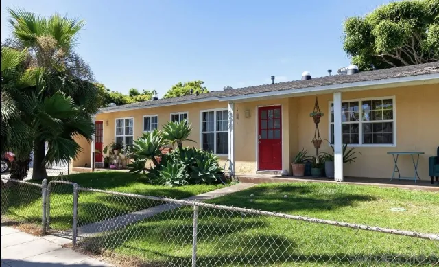 a view of a house with a yard and plants
