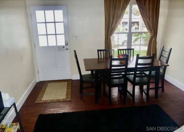 a view of a dining room with furniture and window