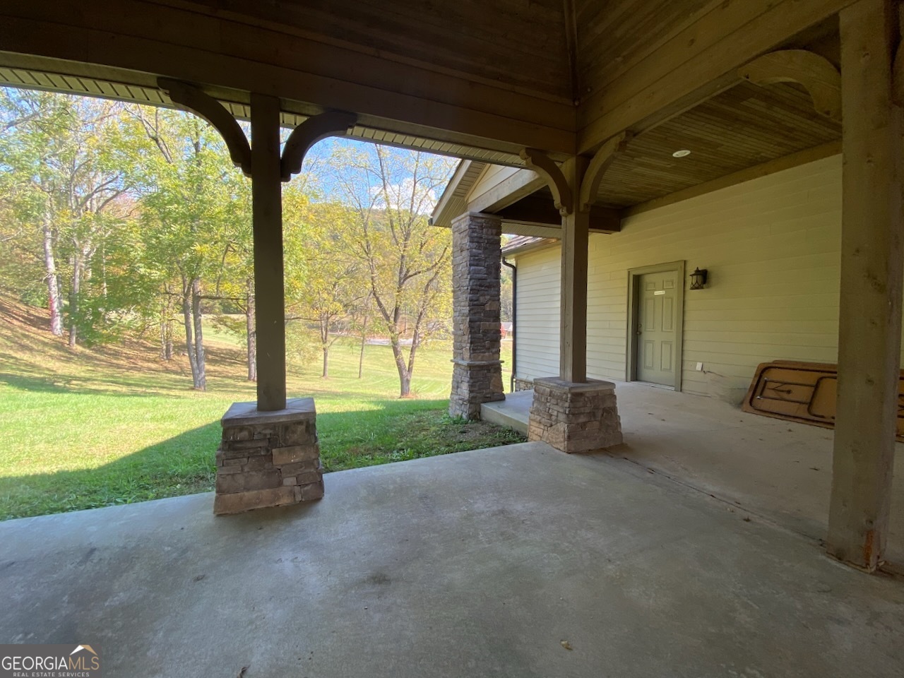 0 Uplander Court Rabun Gap, GA 30568 - Photo 14 of 20 a living room with furniture and floor to ceiling windows