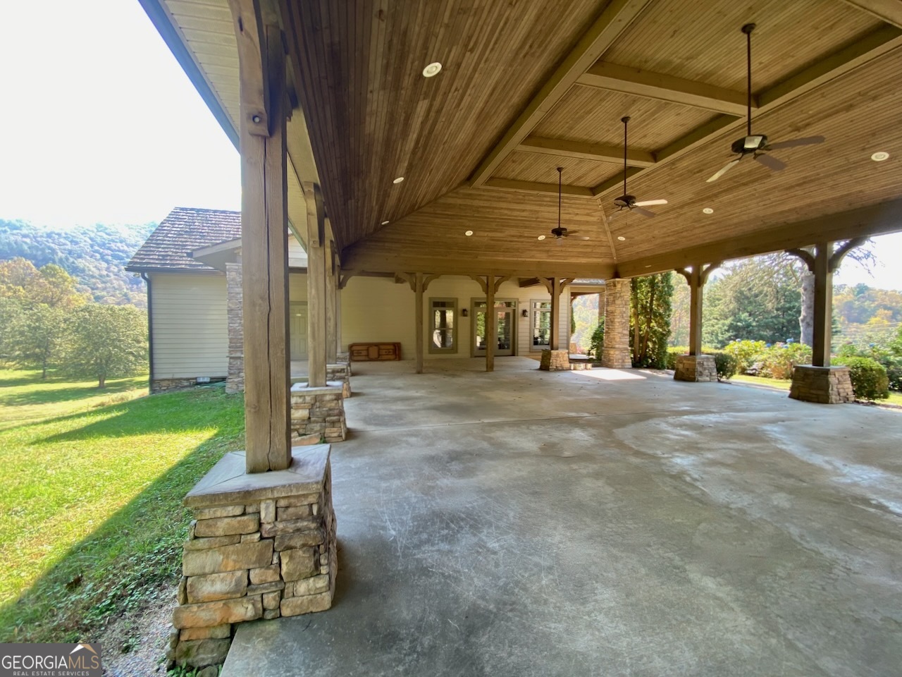 0 Uplander Court Rabun Gap, GA 30568 - Photo 15 of 20 a view of a porch with furniture and a yard