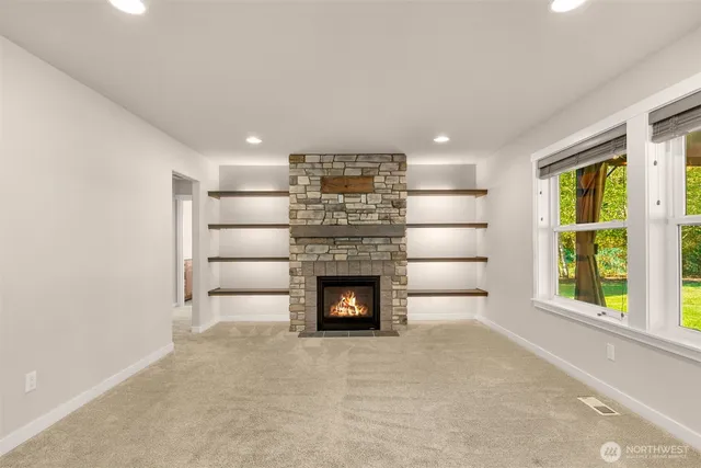 a living room with a fireplace and a large window