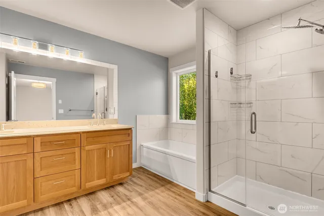 a bathroom with a tub shower and sink