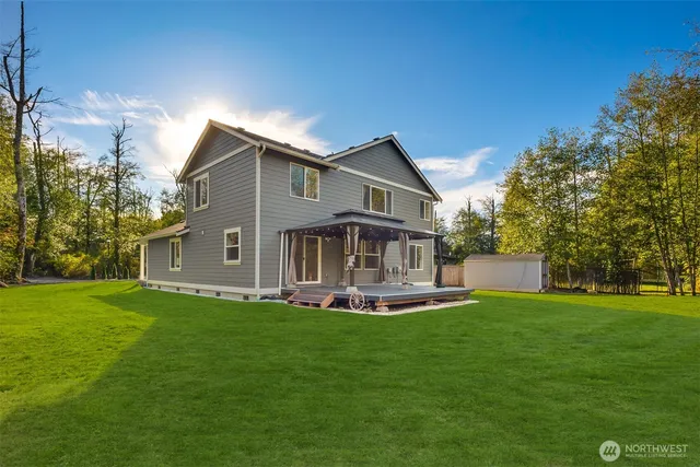 a front view of a house with a yard porch and sitting area