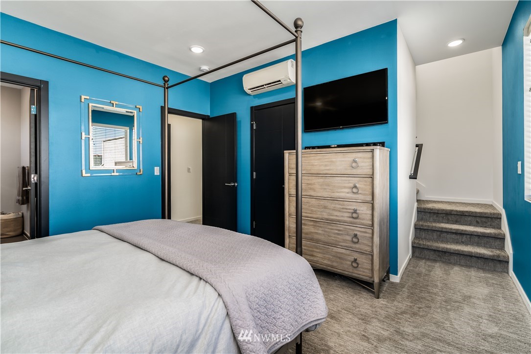 742 North 95th Street Seattle, WA 98103 - Photo 14 of 32 a bedroom with a bed and a flat screen tv