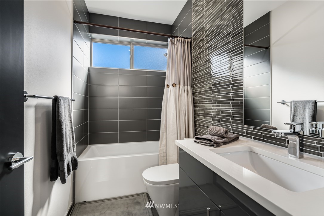 742 North 95th Street Seattle, WA 98103 - Photo 22 of 32 a bathroom with a sink and a mirror