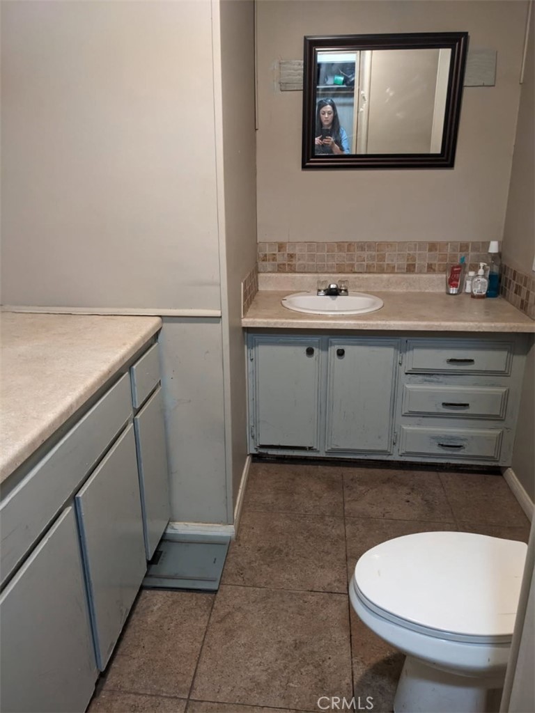 31596 Allen Avenue Homeland, CA 92548 - Photo 3 of 22 a bathroom with a toilet a sink and mirror