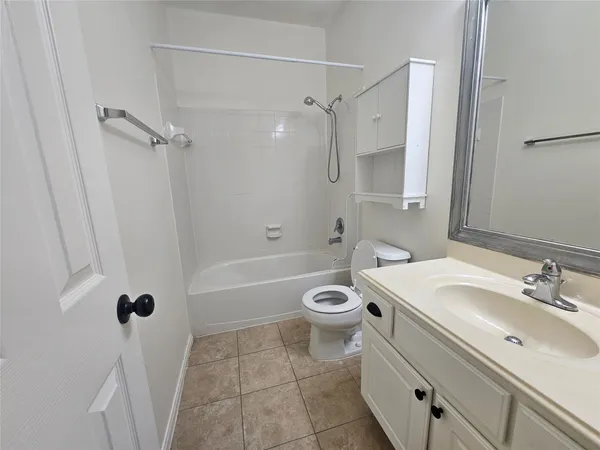 a bathroom with a sink a toilet a mirror and a bathtub