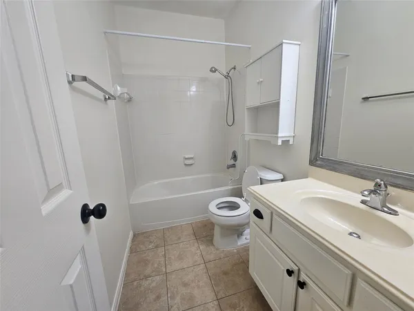 a bathroom with a sink a toilet a mirror and a bathtub