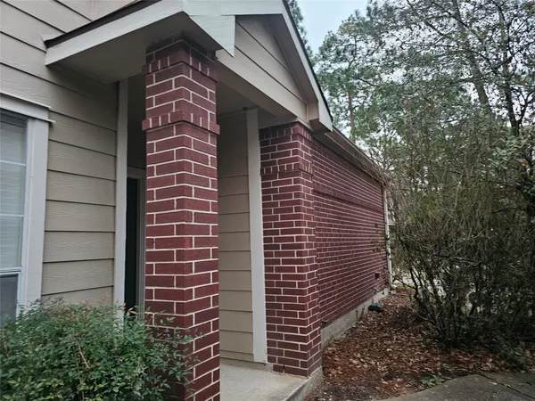 a view of a door and brick wall
