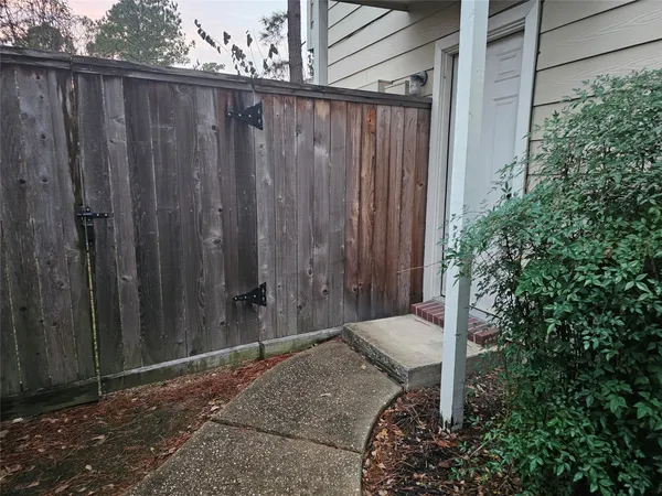 a backyard of a house with a wooden fence