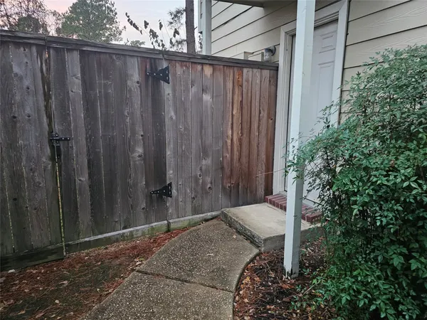 a backyard of a house with a wooden fence
