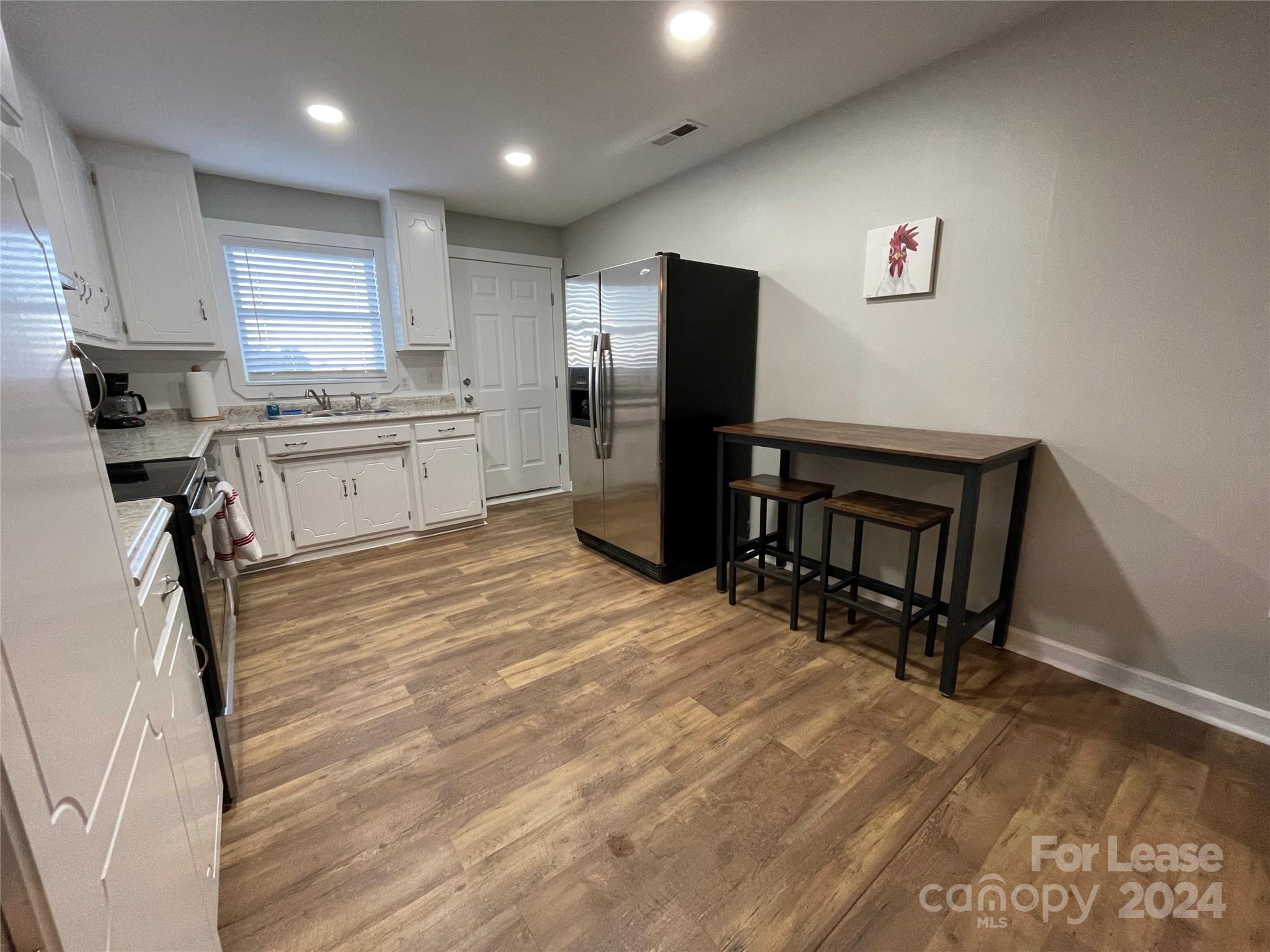 1544 Beth Haven Church Road Denver, NC 28037 - Photo 2 of 13 a kitchen with a refrigerator a stove top oven a counter space and cabinets