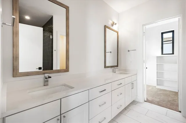 a bathroom with double sink and a mirror