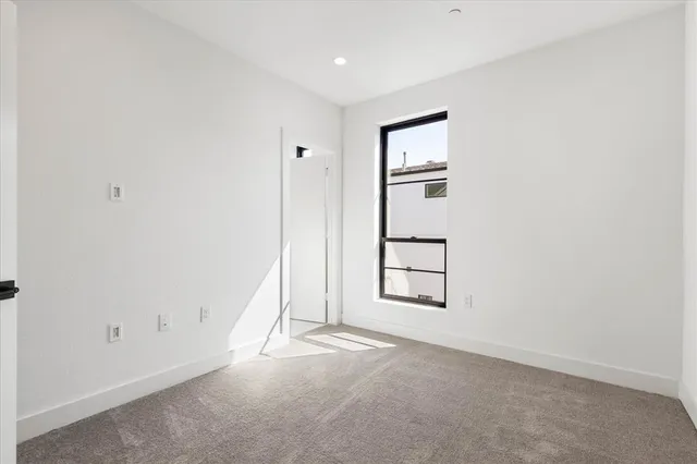 an empty room with windows and closet