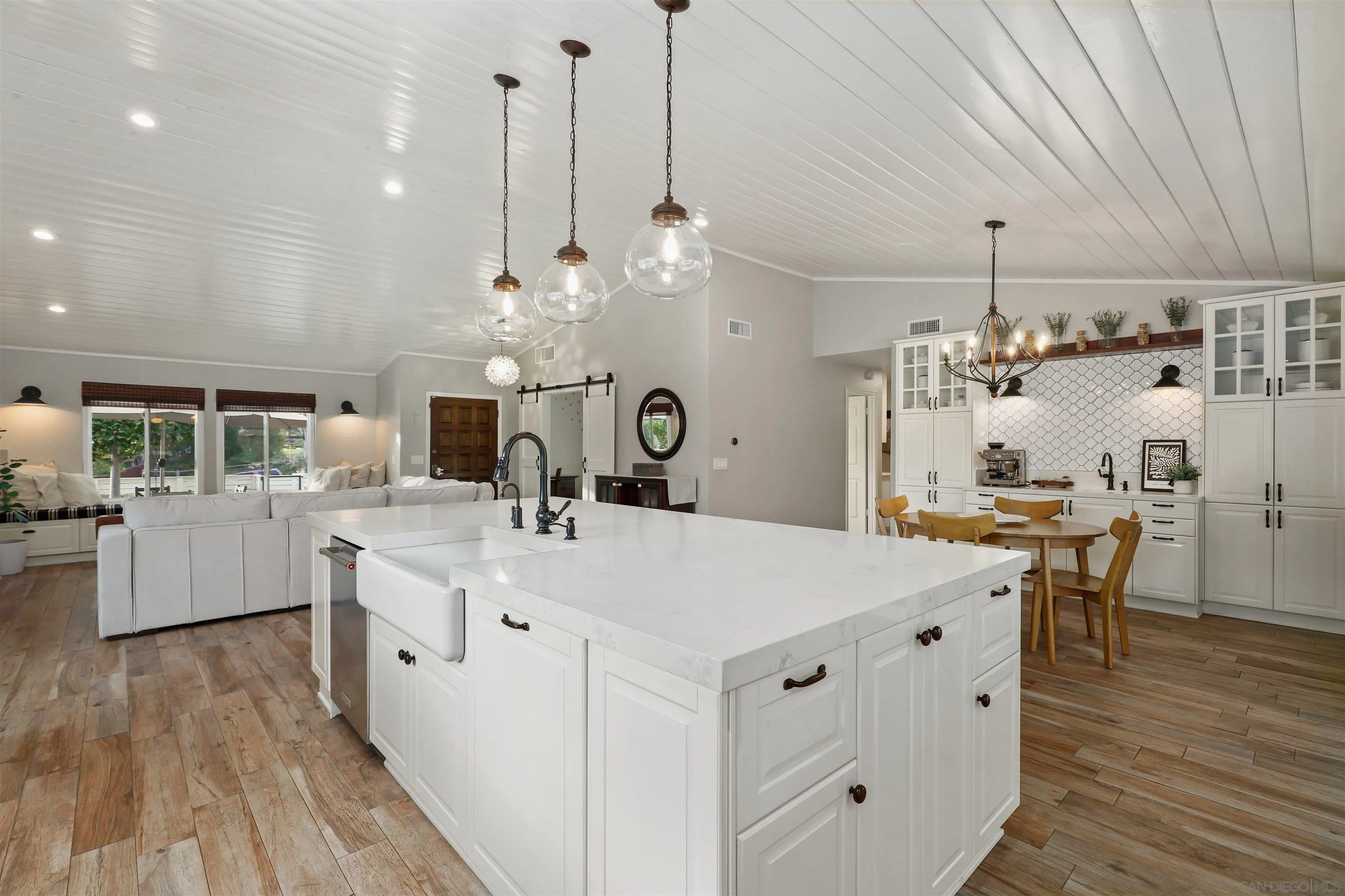 14717 Fieldview Way Poway, CA 92064 - Photo 14 of 35 a large kitchen with kitchen island a stove a sink a center island and wooden floor