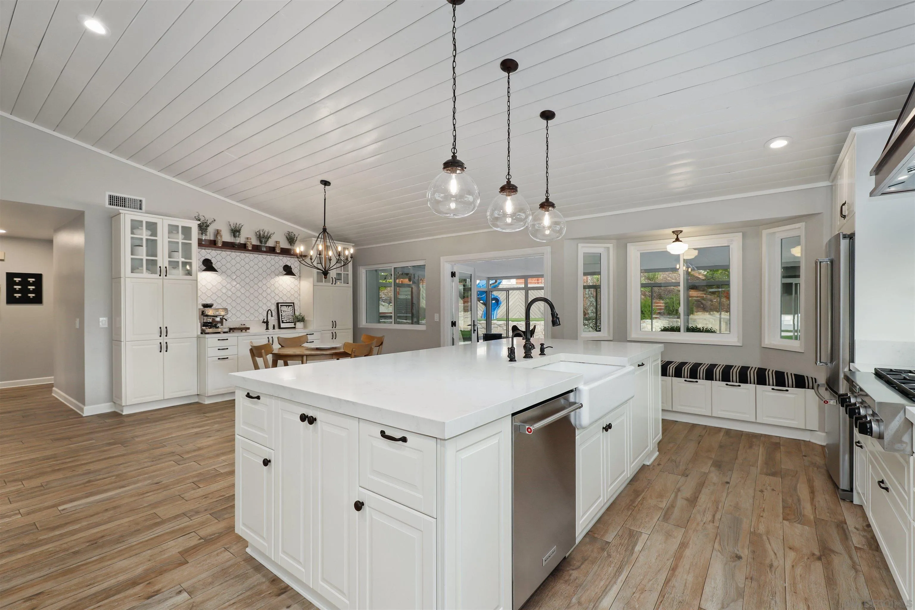 14717 Fieldview Way Poway, CA 92064 - Photo 16 of 35 a large white kitchen with a stove and wooden floor