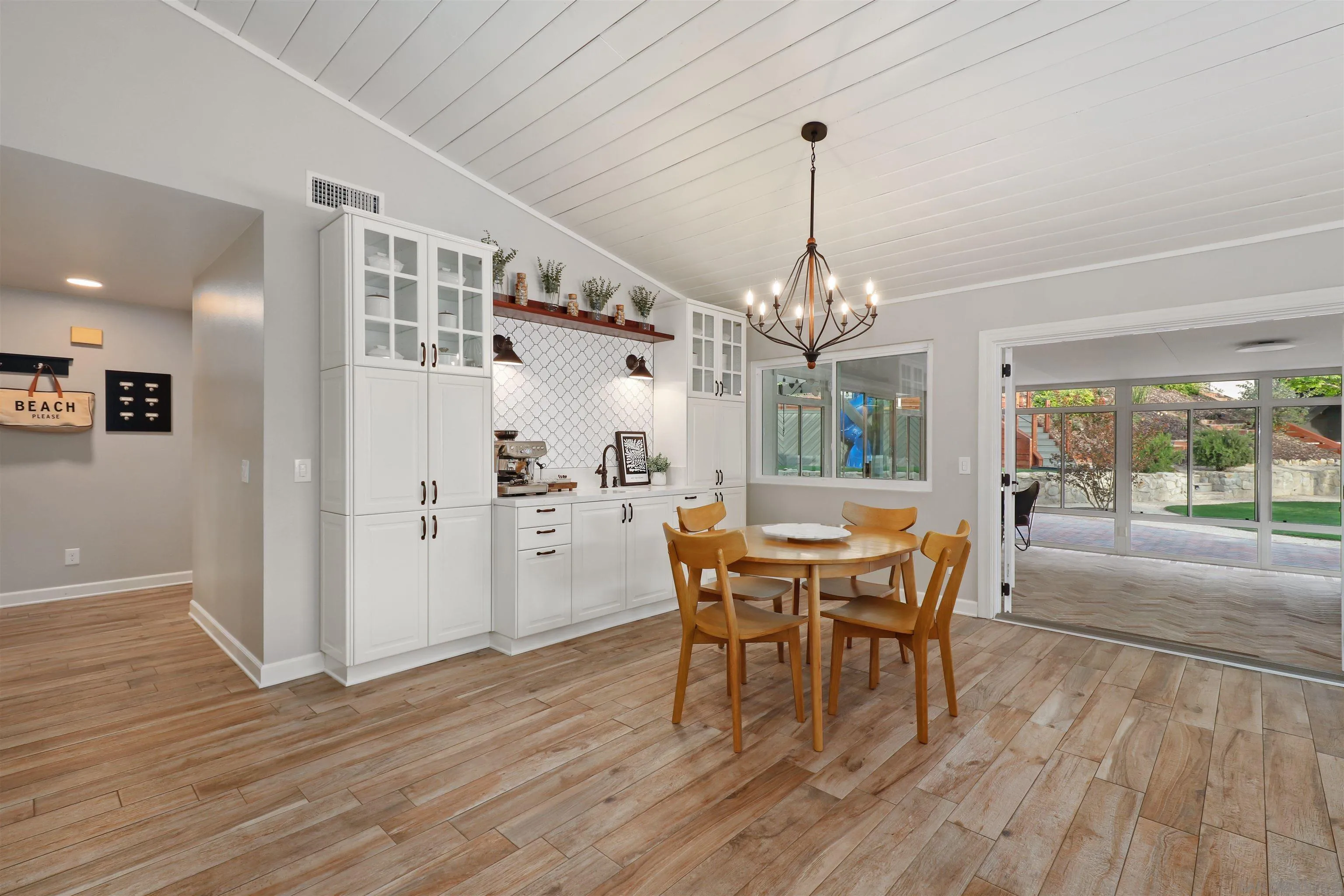 14717 Fieldview Way Poway, CA 92064 - Photo 18 of 35 a dining room with wooden floor a chandelier a wooden table and chairs
