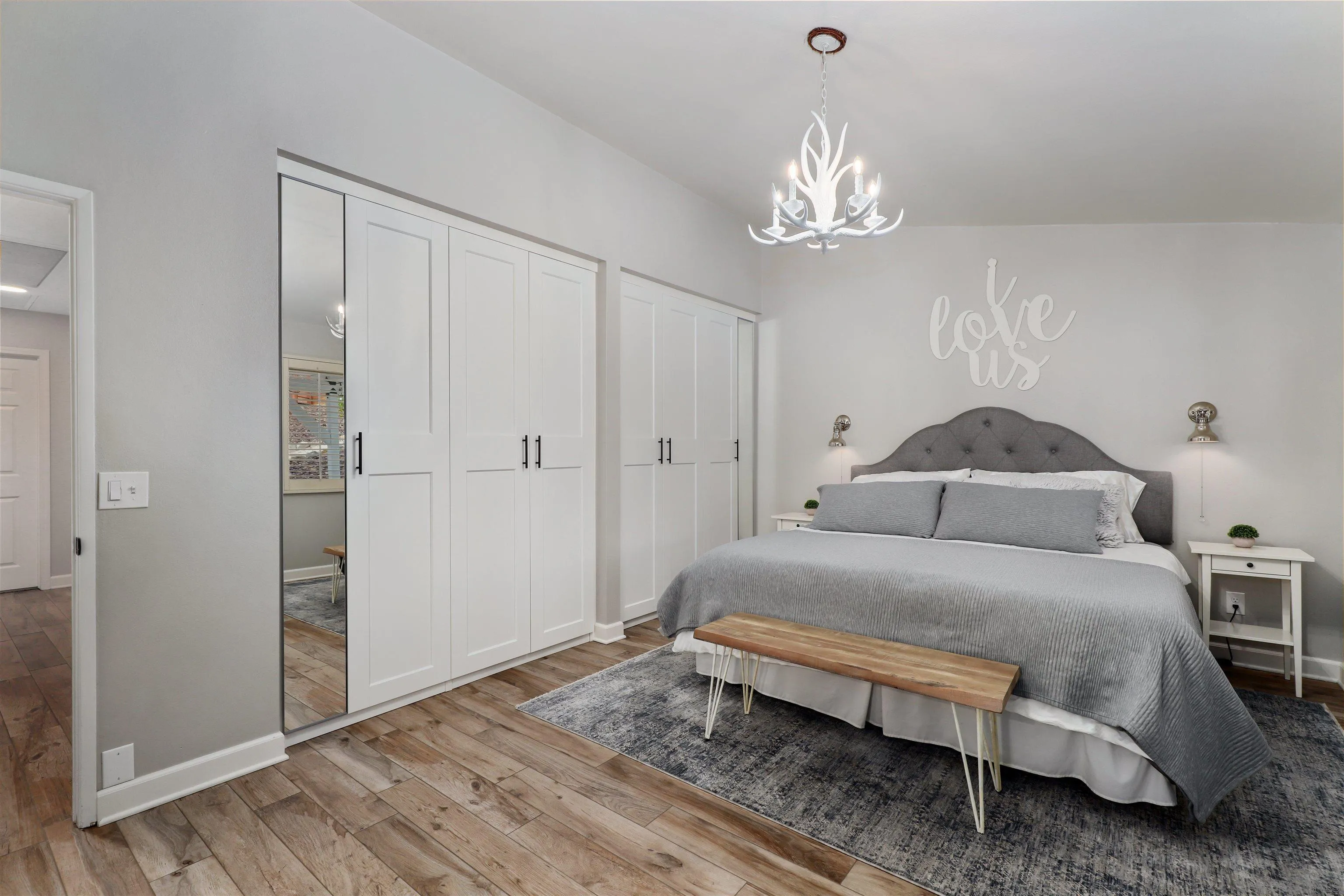 14717 Fieldview Way Poway, CA 92064 - Photo 21 of 35 a spacious bedroom with a bed and a chandelier