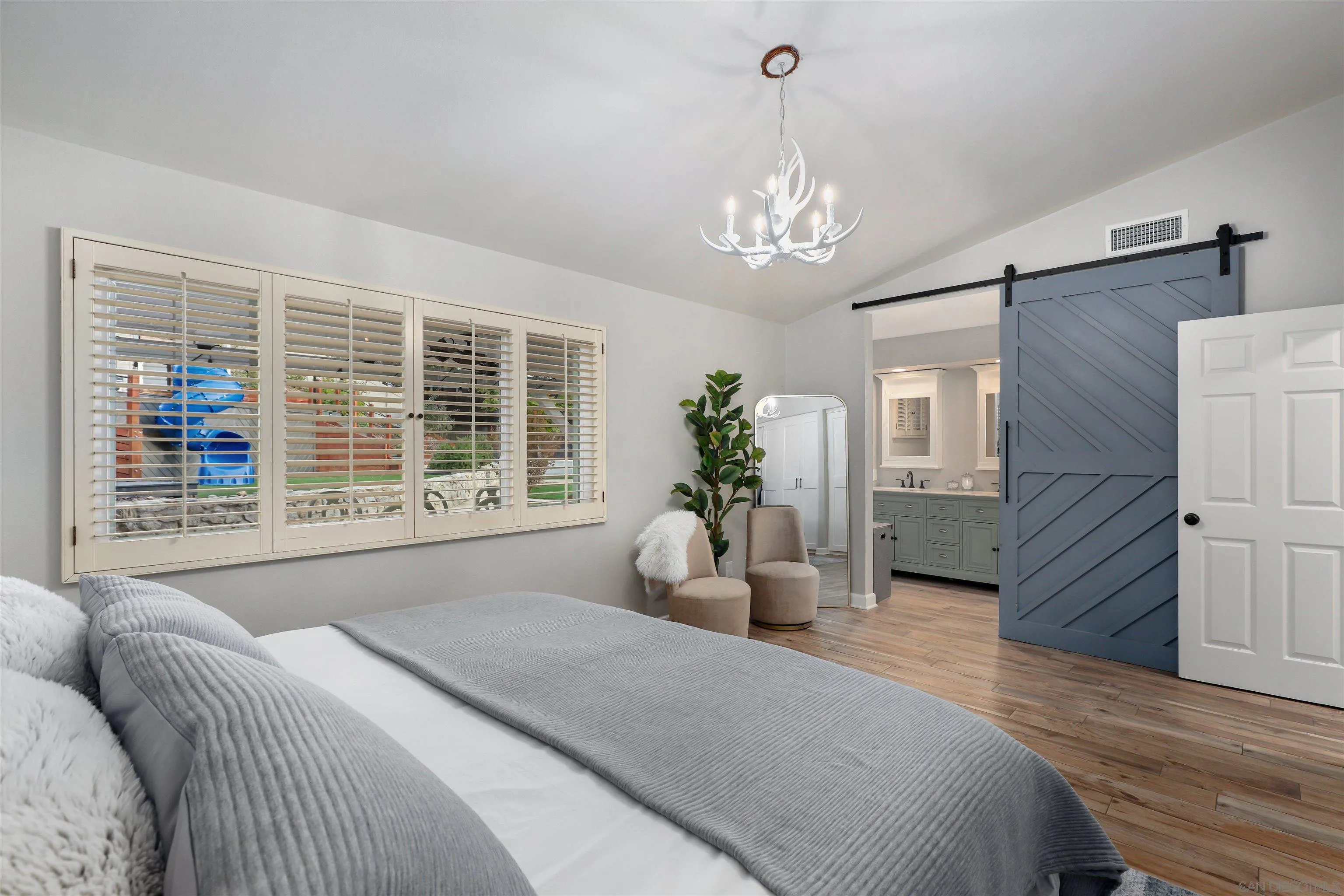 14717 Fieldview Way Poway, CA 92064 - Photo 22 of 35 a spacious bedroom with a large bed and a chandelier