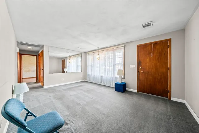 a view of an empty room and glass door