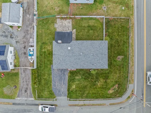 a view of a house with a yard and plants
