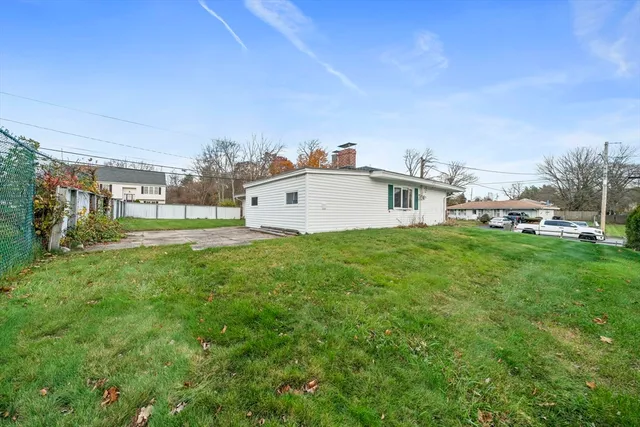 a view of a big room with a big yard and large trees