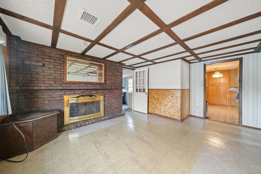 36 Dix Road Brockton, MA 02302 - Photo 7 of 31 a view of an empty room with a fireplace and a window