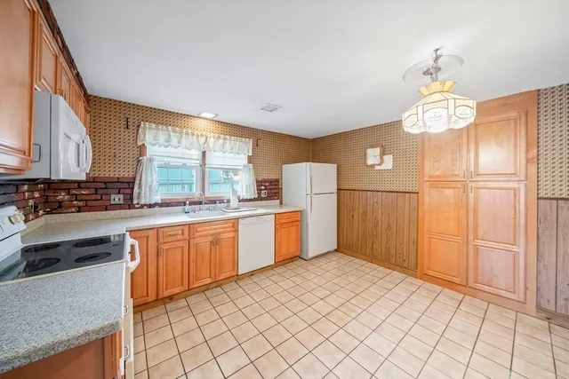 a kitchen with refrigerator cabinets and window