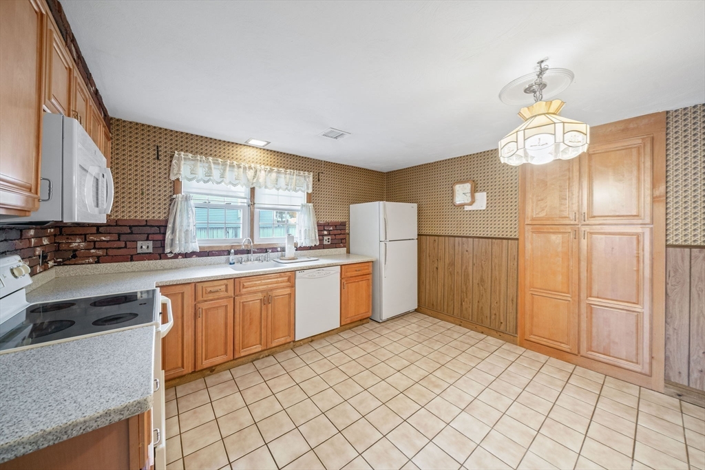 36 Dix Road Brockton, MA 02302 - Photo 8 of 31 a kitchen with refrigerator cabinets and window