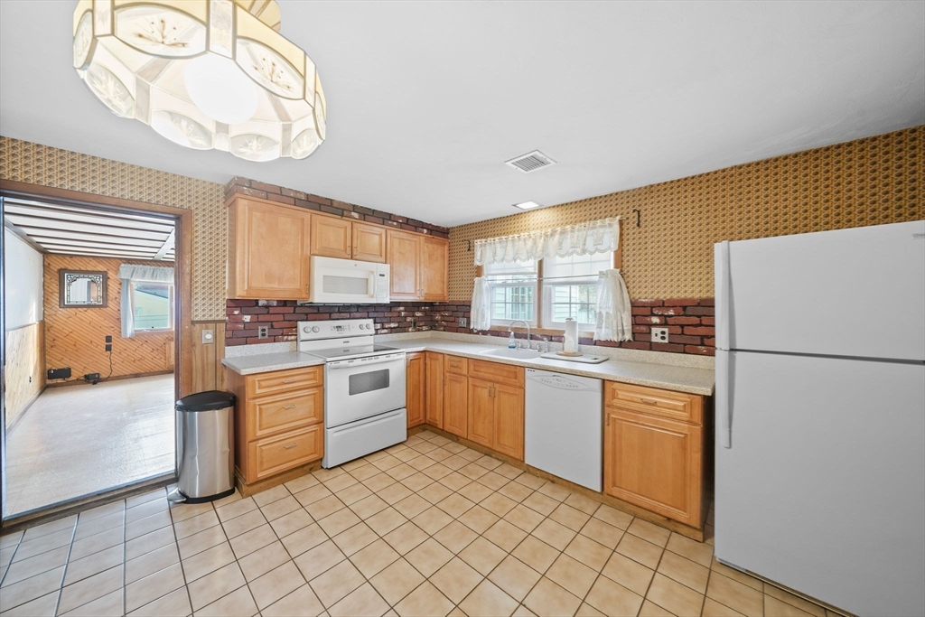 36 Dix Road Brockton, MA 02302 - Photo 9 of 31 a kitchen with granite countertop cabinets and window