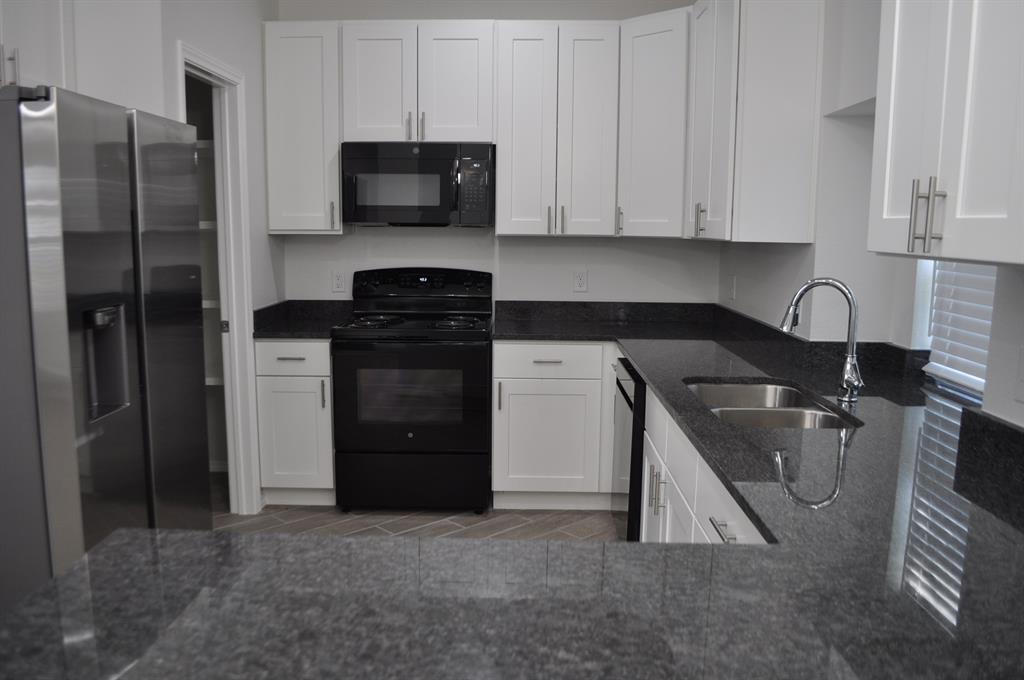 2360 Murphy Court Waxahachie, TX 75165 - Photo 10 of 22 a kitchen with a refrigerator sink and cabinets