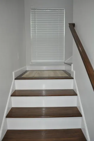 a kitchen with a refrigerator sink and cabinets