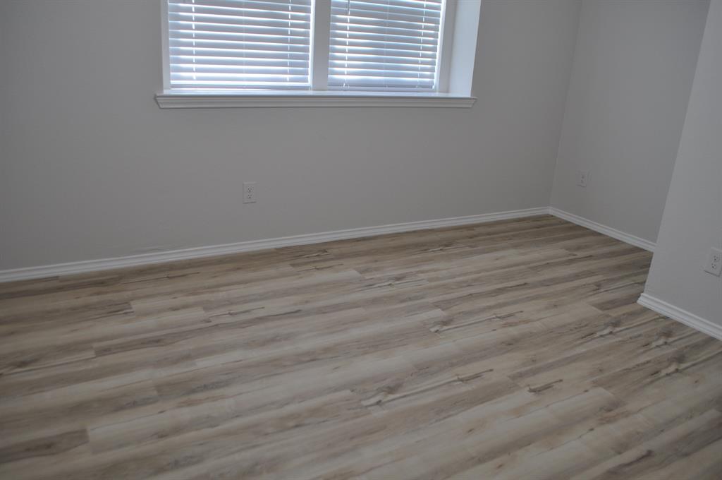 2360 Murphy Court Waxahachie, TX 75165 - Photo 16 of 22 an empty room with wooden floor and windows
