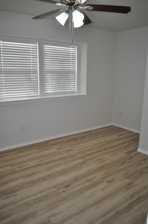 2360 Murphy Court Waxahachie, TX 75165 - Photo 17 of 22 a view of an empty room with wooden floor and a window