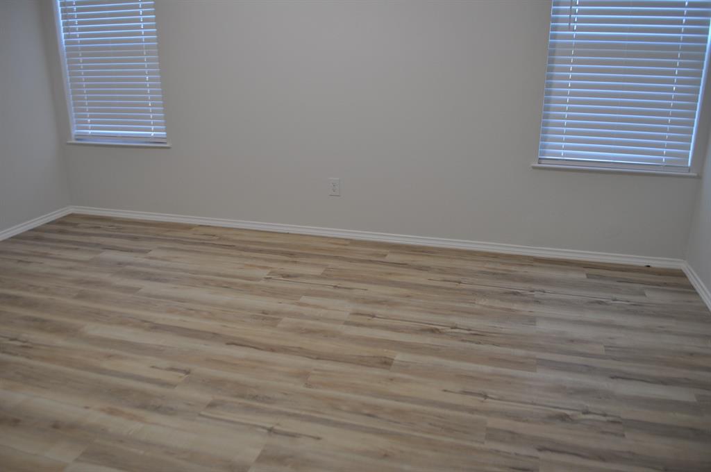 2360 Murphy Court Waxahachie, TX 75165 - Photo 18 of 22 an empty room with wooden floor and windows