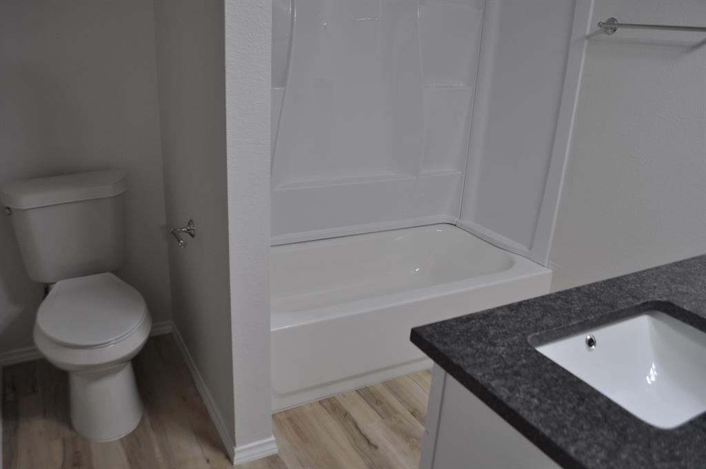 2360 Murphy Court Waxahachie, TX 75165 - Photo 20 of 22 a bathroom with a granite countertop toilet and a sink