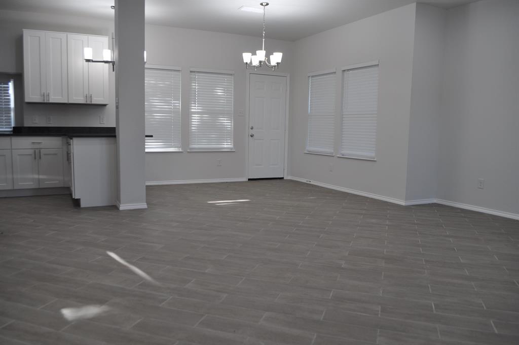 2360 Murphy Court Waxahachie, TX 75165 - Photo 8 of 22 an empty room with windows and cabinet