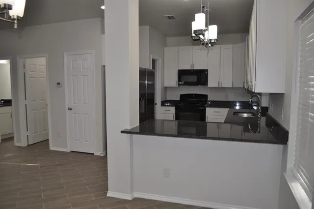 a view of a kitchen with refrigerator and microwave