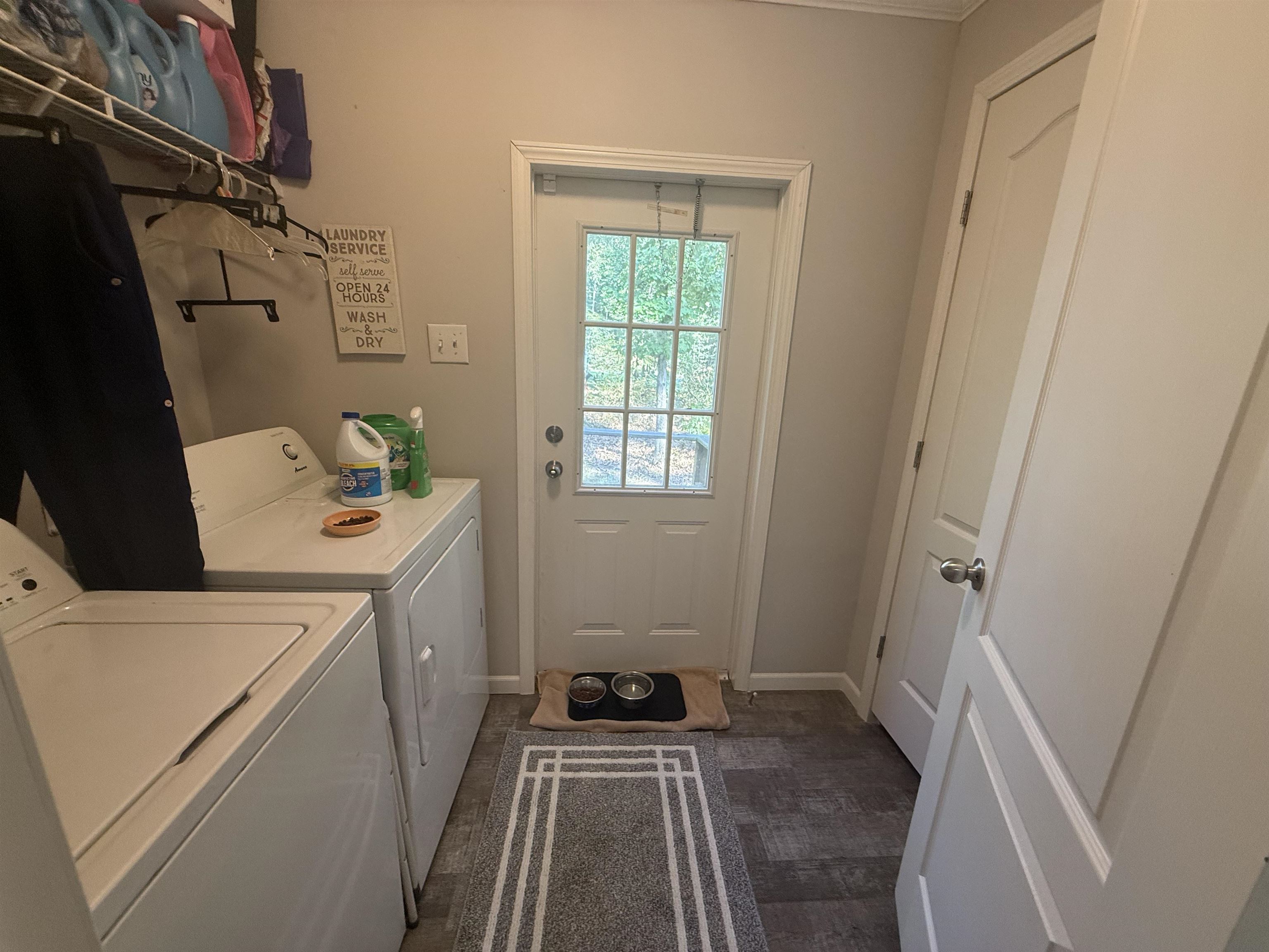 185 Pine Tree Road Moscow, TN 38057 - Photo 26 of 36 Laundry area featuring a grid-paneled door, built-in wire shelving, and wood-finish flooring
