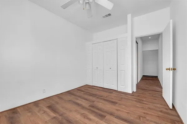 wooden floor in a hall with an empty room